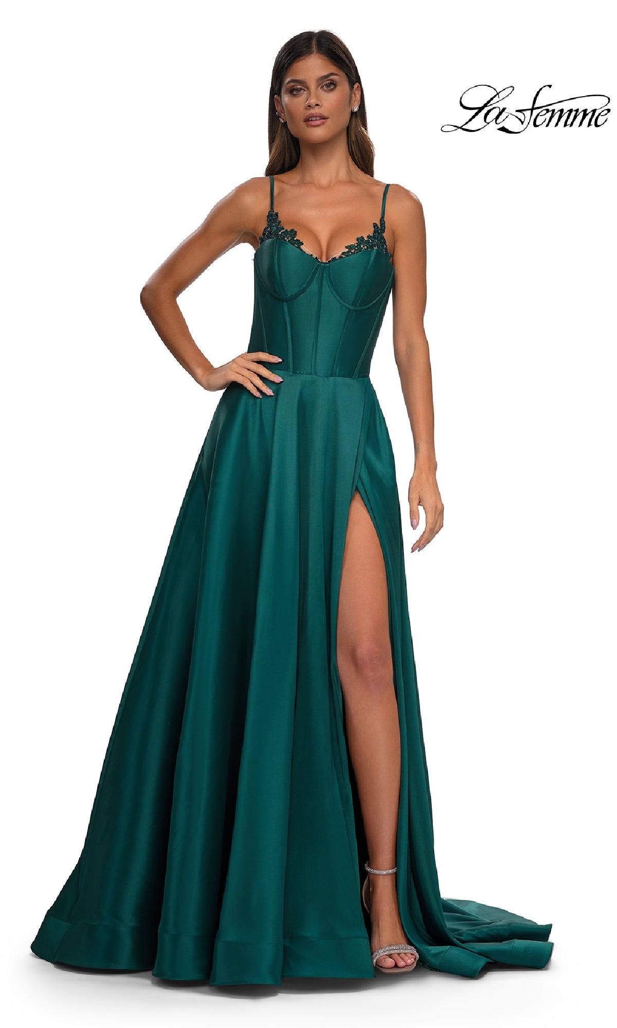 A woman models the Lace-Up Long Mikado Prom Dress: La Femme 32878—featuring a dark green A-line silhouette, spaghetti straps, lace bodice, and high leg slit—against a plain white background.